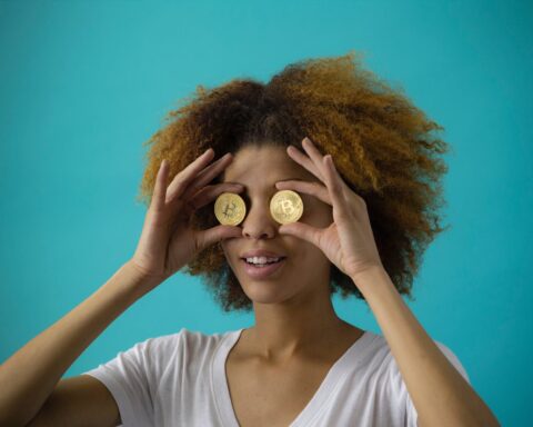 woman holding two coins