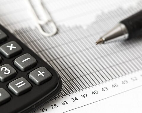 calculator and pen on table